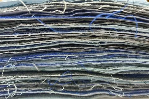 Stack of fabric scraps and textile layers close-up Stock Photos