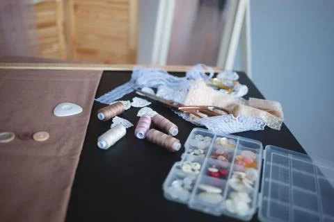 A stack of fabrics and sewing accessories on a tailor's table Fotos de archivo