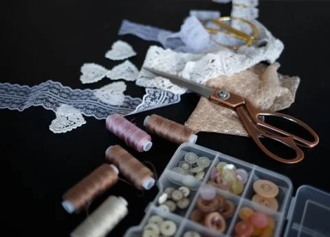 A stack of fabrics and sewing accessories on a tailor's table Stock Photos