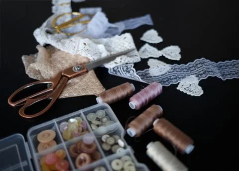 A stack of fabrics and sewing accessories on a tailor's table Stock Photos