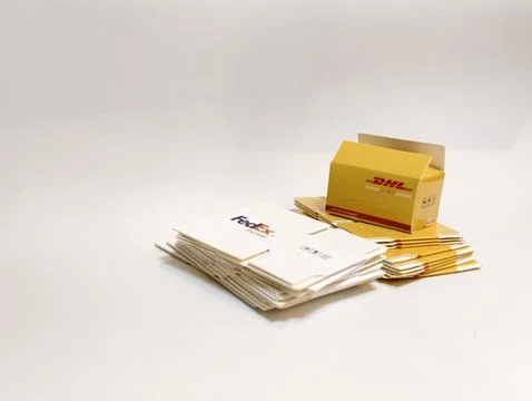 Stack of FedEx and DHL Parcel Box Ready for Express Delivery and Shipping Stock Photos