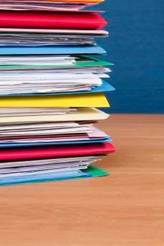 Stack of files on wood surface vertical Stock Photos