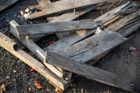 Stack of firewood and burning timber with glowing flames and smoke showing he Stock Photos