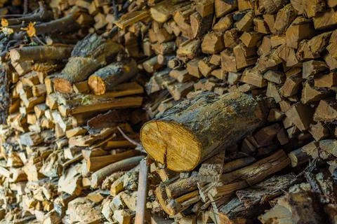 Stack of firewood chunks in a barn Foto stock