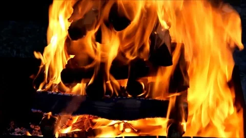 A stack of firewood collapsing under the heat and erupting in flames Stock Footage 77861324