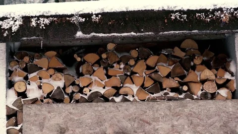A stack of firewood covered with snow, 4K 스톡 동영상 71898729