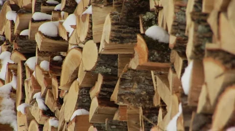 Stack of firewood with gentle snow falling Stock Footage 994333