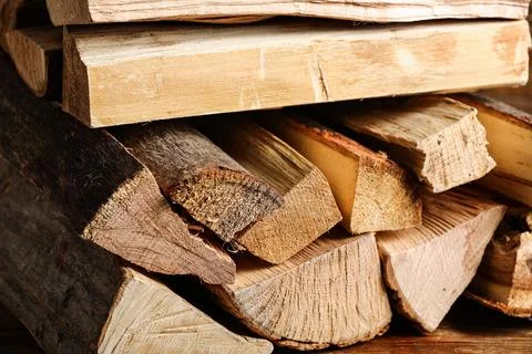 Stack of firewood logs as background, closeup Stock Photos