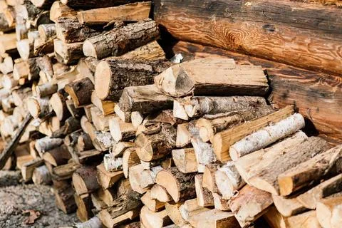 Stack of firewood logs with wood splitter in outdoor setting Fotos de archivo