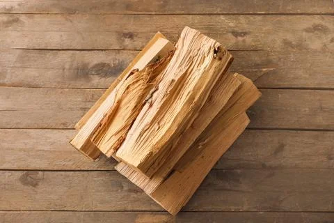 Stack of firewood logs on wooden background Stock Photos