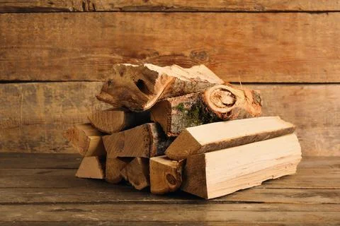 Stack of firewood logs on wooden background Stock Photos