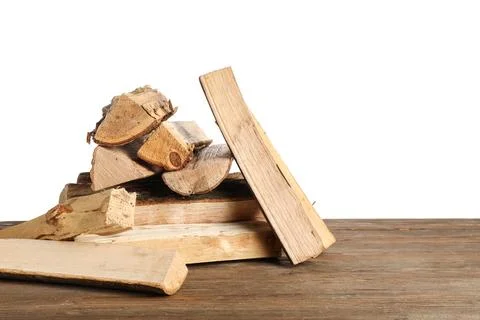 Stack of firewood logs on wooden table against white background Stock Photos