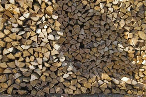 Stack of firewood piled by house Stock Photos