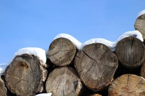 Stack of firewood snow covered in winter Stock Photos