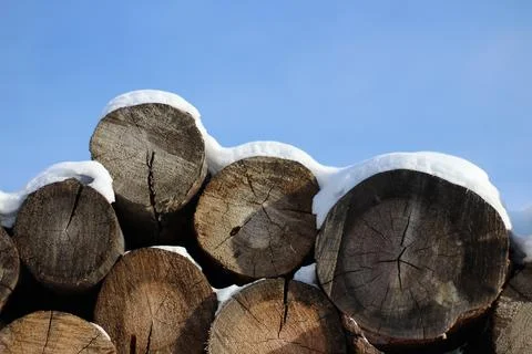 Stack of firewood snow covered in winter Stock Photos