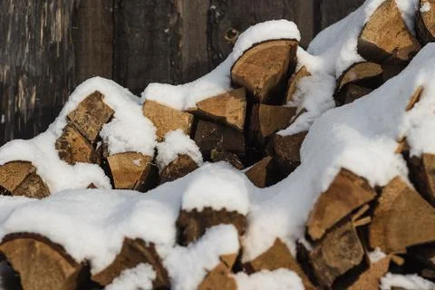 Stack of firewood snow covered in winter Stock Photos