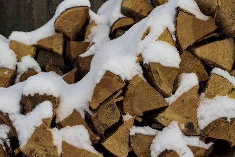Stack of firewood snow covered in winter Stock Photos