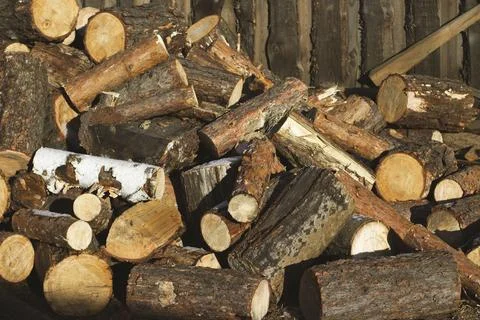 Stack of firewood snow covered in winter Stock Photos
