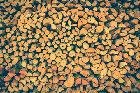 Stack of firewood, wood background texture. Retro style. Stock Photos