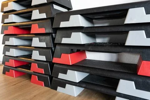 Stack of fitness stepper in front of white background with wooden oak floor i Stock-Fotos