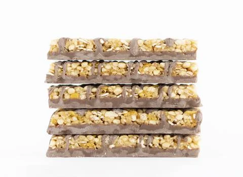 A stack of five corn bars on a white background. A quick snack on the go. Stock Photos
