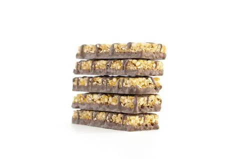 A stack of five corn bars on a white background. A quick snack on the go. Stock Photos