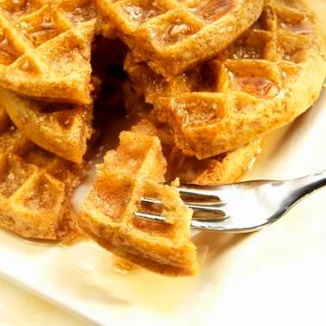 Stack of Five Grain Waffle with Organic Maple Syrup; Piece on a Fork 스톡 사진