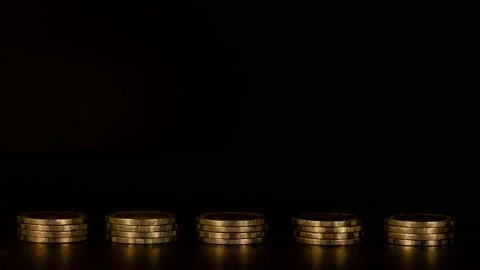 Stack of five piles of gold cash coins increasing fading disappear 動画素材 154543263