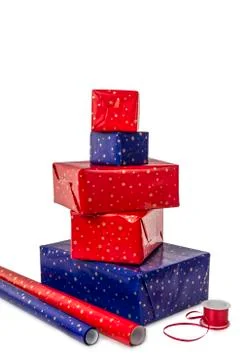 Stack of five presents and wrapping paper Stock Photos