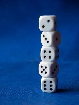 Stack of Five White Dice on Blue Background Stock Photos
