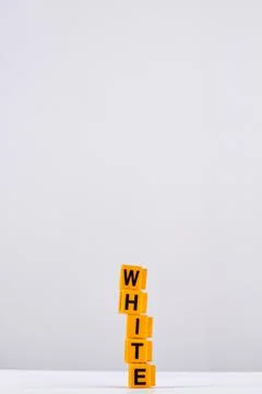 Stack of five yellow cubes arranged in word white. 写真素材