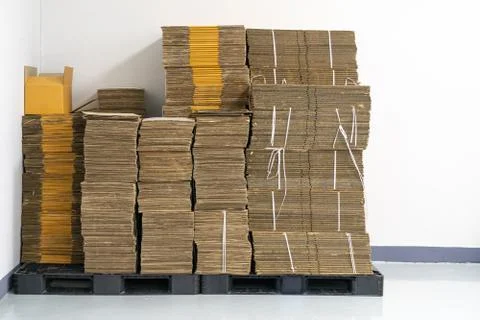 Stack of flat pack cardboard boxes for product packaging and delivery. Stock Photos