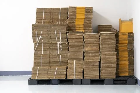 Stack of flat pack cardboard boxes for product packaging and delivery. Stock Photos