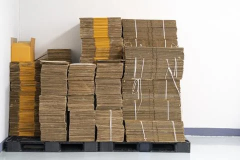 Stack of flat pack cardboard boxes for product packaging and delivery. Stock Photos