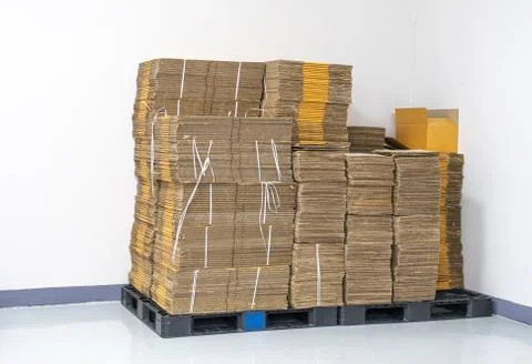 Stack of flat pack cardboard boxes for product packaging and delivery. Stock Photos
