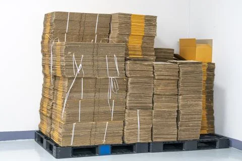 Stack of flat pack cardboard boxes for product packaging and delivery. Stock Photos