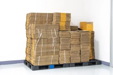 Stack of flat pack cardboard boxes for product packaging and delivery. Stock Photos