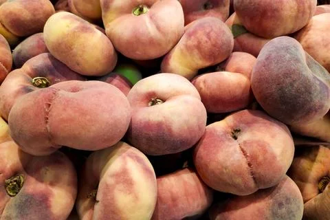 Stack of Flat peaches on a market stall Stock Photos
