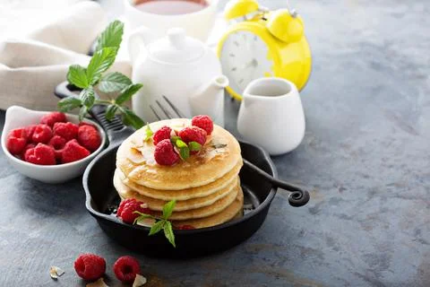 Stack of fluffy buttermilk pancakes with raspberry and coconut Stock Photos