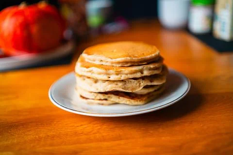 Stack of Fluffy Soft Delicious Homemade Pancakes on a White Plate Sitting o.. Stock Photos