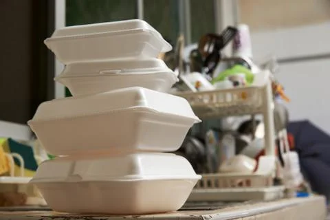 Stack of foam packagings after meal in the kitchen. Stock Photos
