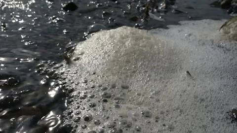 Stack of foam on the shore of Lake accumulated torrential waves Stock Footage 138011683