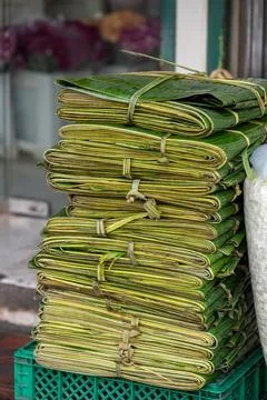 Stack of folded banana leaves for packaging at Bangkok market Stock Photos
