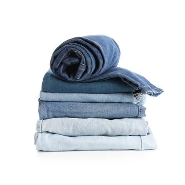 Stack of folded blue jeans with a rolled pair on top, denim clothing and fash Fotos Stock
