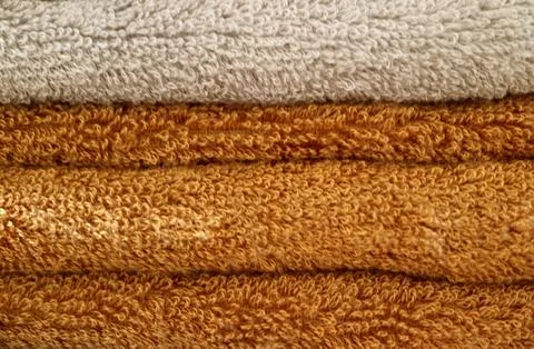Stack of folded brown and beige fluffy bath towels Photos