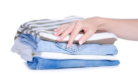 Stack folded cloth jeans sweaters in hand Stock Photos