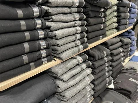 Stack Of folded clothes for sale in store Foto stock