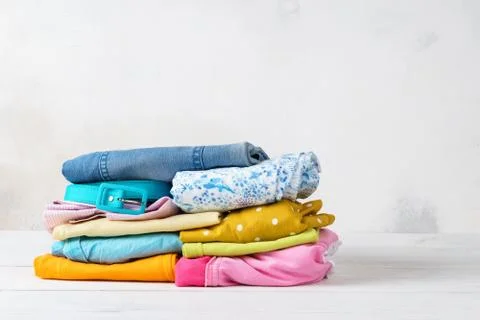 Stack of folded, colorful clean casual clothes. Stock Photos