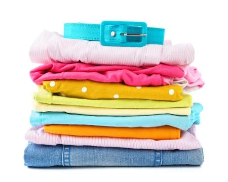 Stack of folded colorful clothes for children and teens. Stock Photos