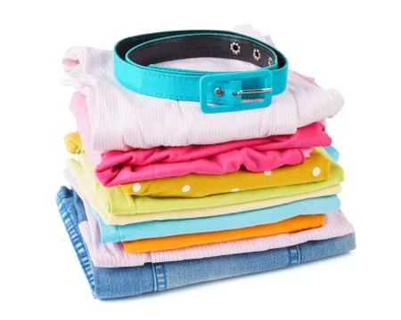Stack of folded colorful clothes for children and teens. Stock Photos
